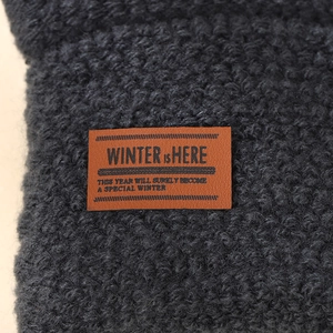 Men's dark grey winter gloves with touch screen tips and brown leather patch
