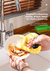 Thick microfiber cleaning cloth wiping oil off a ceramic plate in a kitchen sink