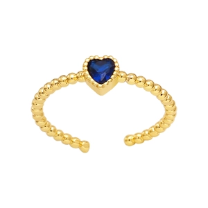 Macro detail of a beaded gold ring featuring a heart-shaped blue sapphire gemstone