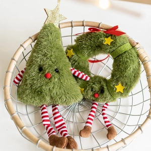 Christmas plush wreath and tree decorations with red striped limbs in a woven basket