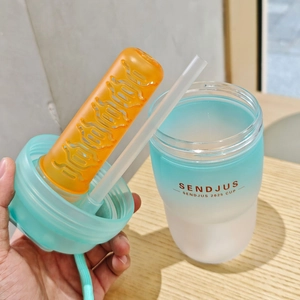 Detail view of the gradient blue water bottle with integrated fruit infuser and straw