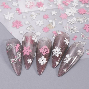 Pink and white Christmas nail stickers with snowflakes and angels on purple glitter tips