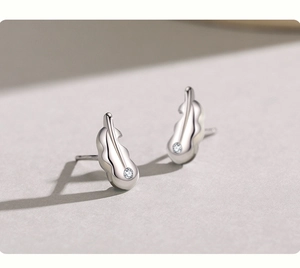 Detailed close-up of leaf-shaped S925 sterling silver studs with micro-inlaid cubic zirconia