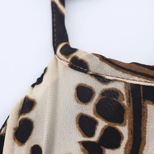 Detail of leopard print halter neckline with high-quality fabric texture and fine stitching