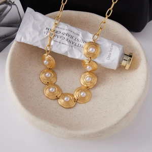 Golden titanium steel necklace with circular pearl pendants on a stylish chain link