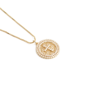 Golden round hollow necklace with zircon cross pendant on a white background