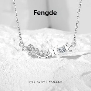 Detail of S925 sterling silver necklace with heart, butterfly and crown pendants