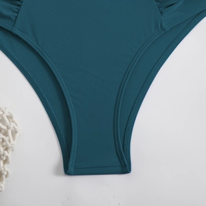 Detailed view of teal bikini bottoms with reinforced double-needle stitching and smooth fabric