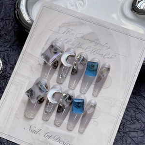 Handmade ice blue cat-eye press-on nails with luxury rhinestones and crystal charms