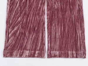 Detail of dusty pink pleated velvet trouser cuffs with premium shimmering texture