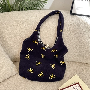 Sac fourre-tout en peluche noire avec nœud brodé jaune et doublure vichy