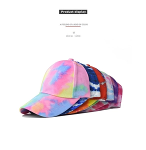 Detail view of multi-color tie-dye cotton baseball caps showing fabric texture and patterns