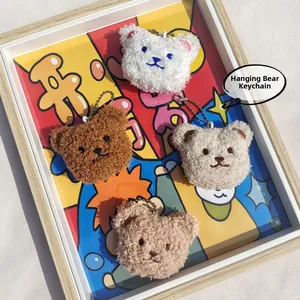 Close-up of curly plush bear head pendants with bead chains in four neutral colors