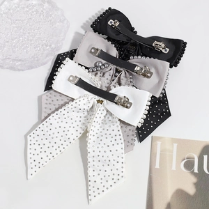 Three elegant bow hair clips with pearls and rhinestones in black, grey, and white