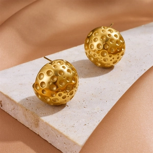 18k gold plated hollow ball earrings with a unique meteorite texture on a stone stand
