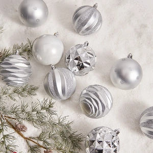 Silver Christmas tree ornaments set with varied textures on a snowy background