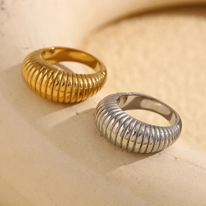 Macro shot of 18K gold and silver croissant rings with ribbed texture on stone