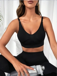 Close-up of black seamless V-neck sports bra with ruched detail and thin straps