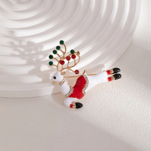 Detail of a Christmas reindeer brooch with white enamel, red rhinestones and gold plating