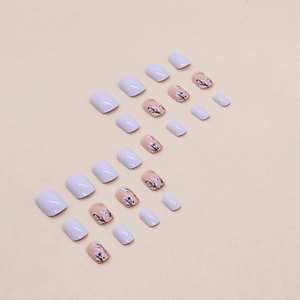 Lavender purple press-on nails set with delicate white floral designs and gold leaf accents