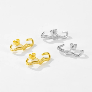 Detailed view of wave-shaped S925 silver stud earrings with zircon in gold and silver