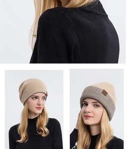 Close-up of the double-sided beige knit beanie featuring ribbed texture and leather patch