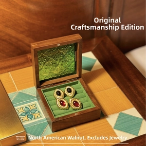 Macro detail of walnut wood jewelry box with vintage green embossed glass lid