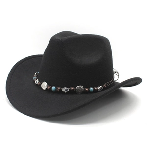 Detail of black felt cowboy hat with ethnic beads and silver hamsa metal decoration