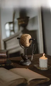 Detail of vintage cast iron twine holder with bird motif, scissors, and rustic rope