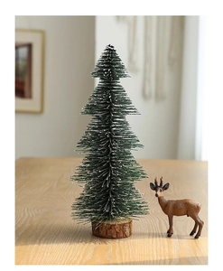 Mini frosted desktop Christmas tree with snow-flocked branches and a wooden base