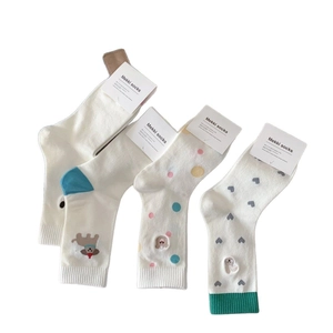 Four pairs of breathable cotton crew socks featuring cute cartoon dog and polka dot patterns