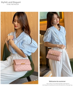 Pink quilted crossbody bag with gold chain strap and metal trim detail shown on model