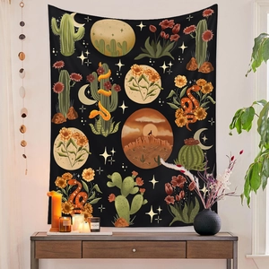 Detail of wall tapestry featuring desert cactus, moon and snake patterns in vivid colors