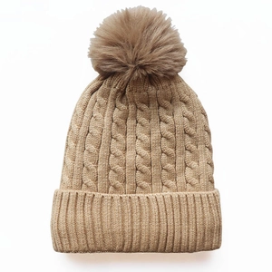 Chunky cable knit beanie with fluffy faux fur pompom in beige for winter warmth