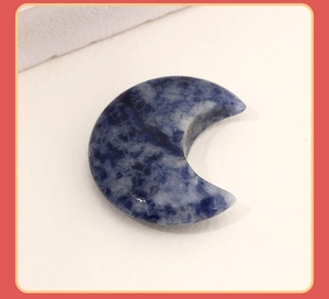 Macro shot of crescent moon stone pendant with unique blue and white vein texture