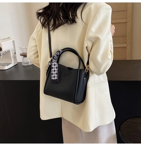 Chic black litchi pattern bucket bag with houndstooth silk scarf and fashion bag tag