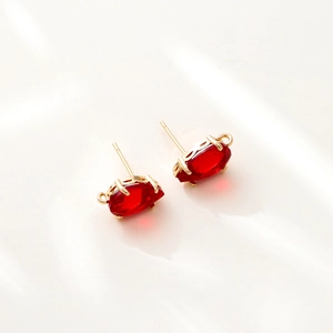 Detailed view of red marquise cut zircon earrings with gold plated 14k copper settings