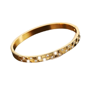 Gold titanium steel bracelet featuring a waffle grid pattern with inlaid crystals
