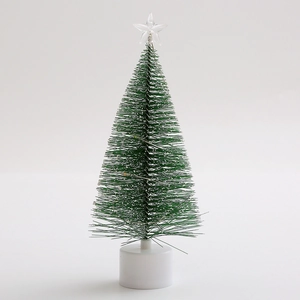 Close-up of mini pine needle Christmas tree with LED lights and star tree topper