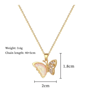 Macro shot showing golden butterfly pendant dimensions and pink iridescent wings