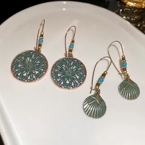 Bohemian hollow flower and starfish drop earrings with turquoise beads in bronze finish