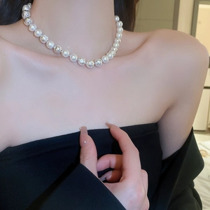Elegant faux pearl choker necklace with silver hollow geometric beads on a model