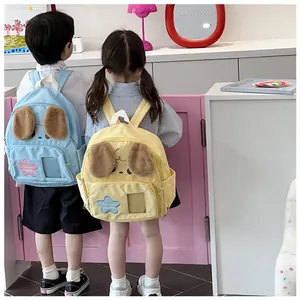 Detail view of cute dog-shaped kids backpack with plush ears and star pattern