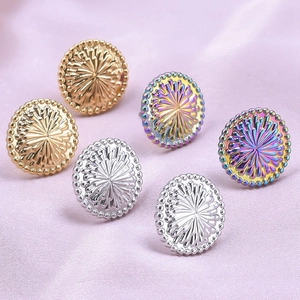 Detailed view of three pairs of sunflower stud earrings in gold, silver, and rainbow steel