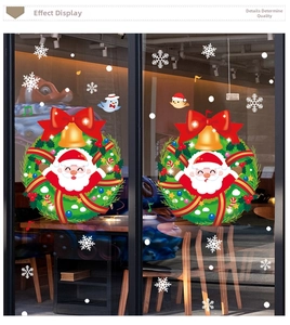 Detail of Christmas window clings with Santa Claus wreaths, red bows and golden bells