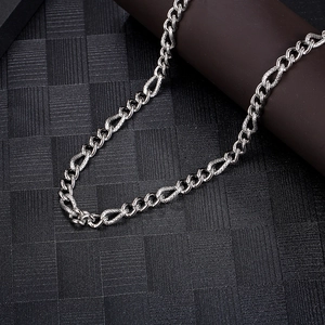 Macro shot of silver titanium steel Cuban link chain with detailed woven texture