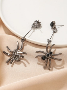 Exaggerated black spider drop earrings with round black gemstones in gothic punk style