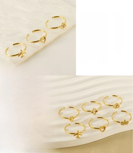 Close-up of 18K gold plated stainless steel open rings with various cute charms
