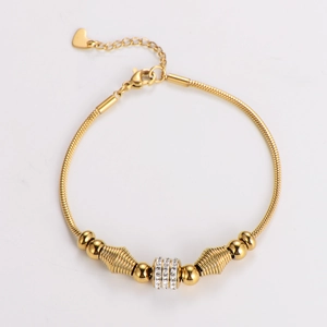 Close-up of golden snake chain bracelet with sparkling rhinestone decorative ring