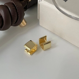 Detail showing the S925 hallmark on minimalist square gold sterling silver earrings
